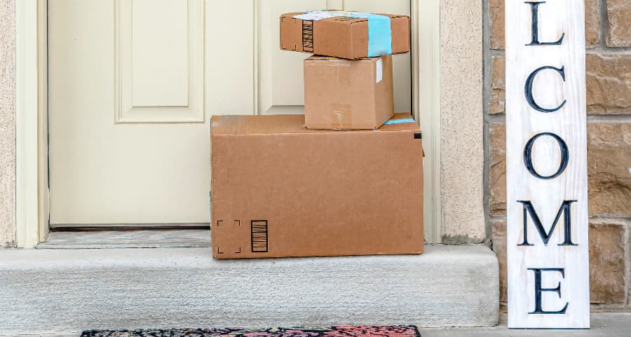 Boxes by the door of a residence with a welcome sign in Wichita Falls